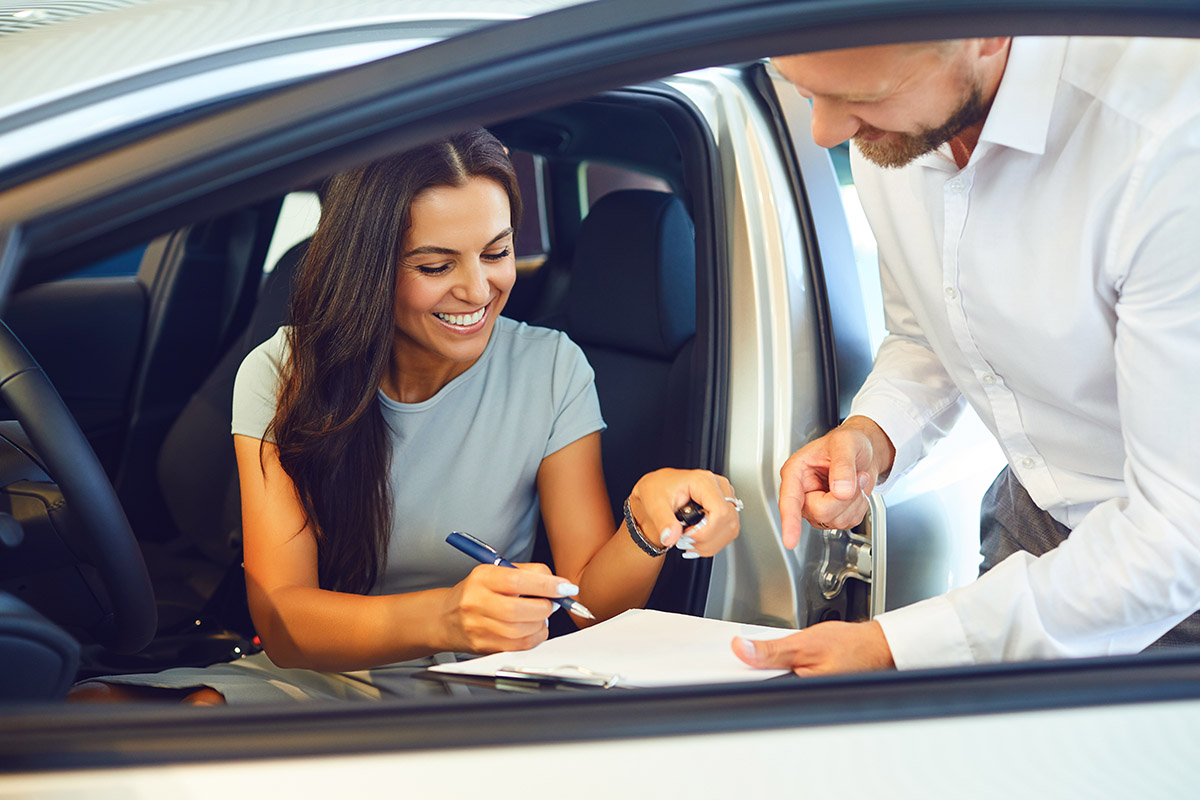 young woman buys a car
